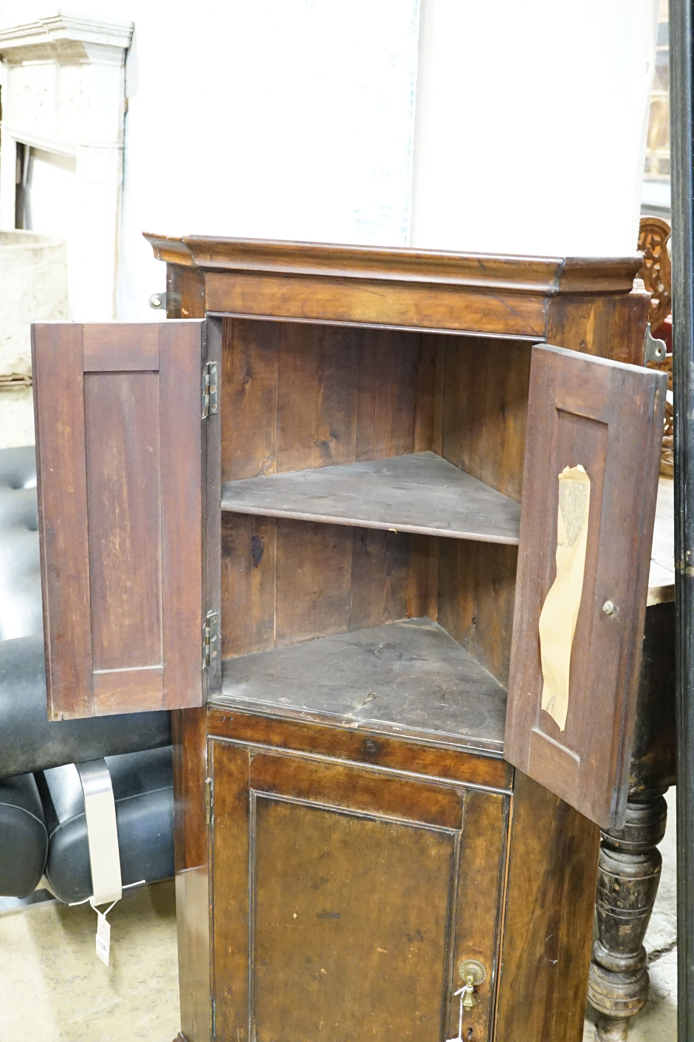 An Edwardian mahogany three door hanging corner cupboard, width 60cm, height 113cm